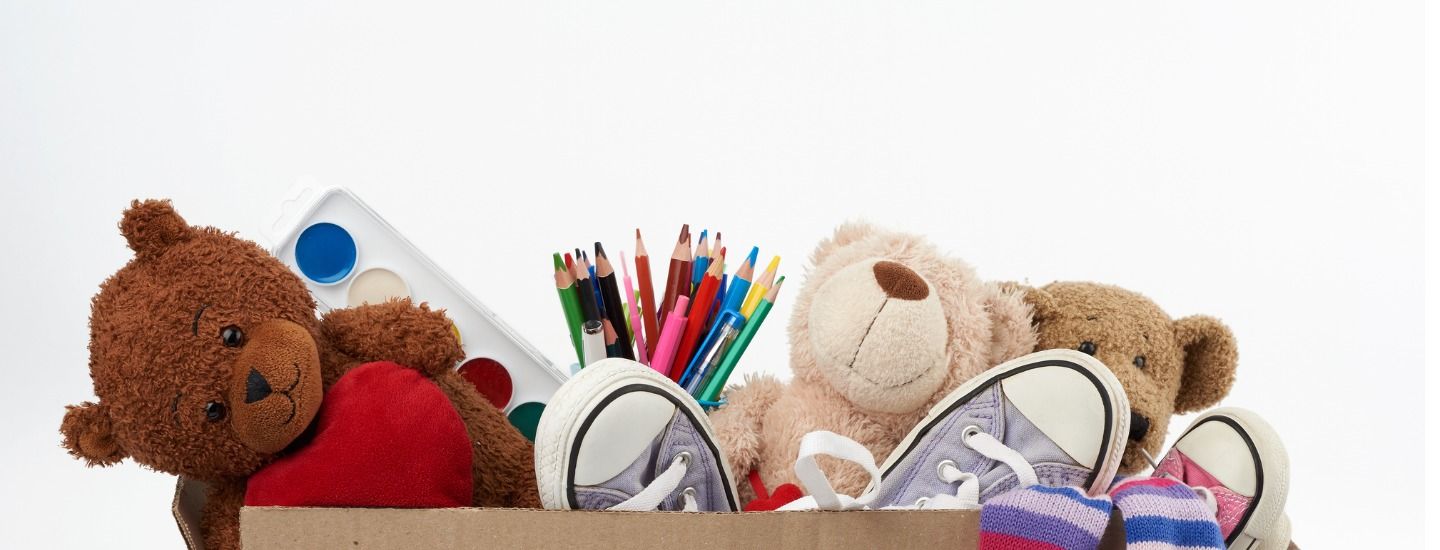 brown cardboard box filled with soft-toys and school supplies